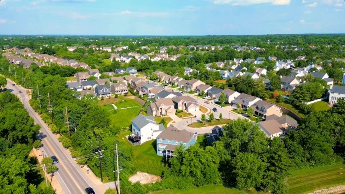 Aerial view of a Wildwood, MO neighborhood with tree-lined streets, spacious lots, and single-family homes in West St. Louis County